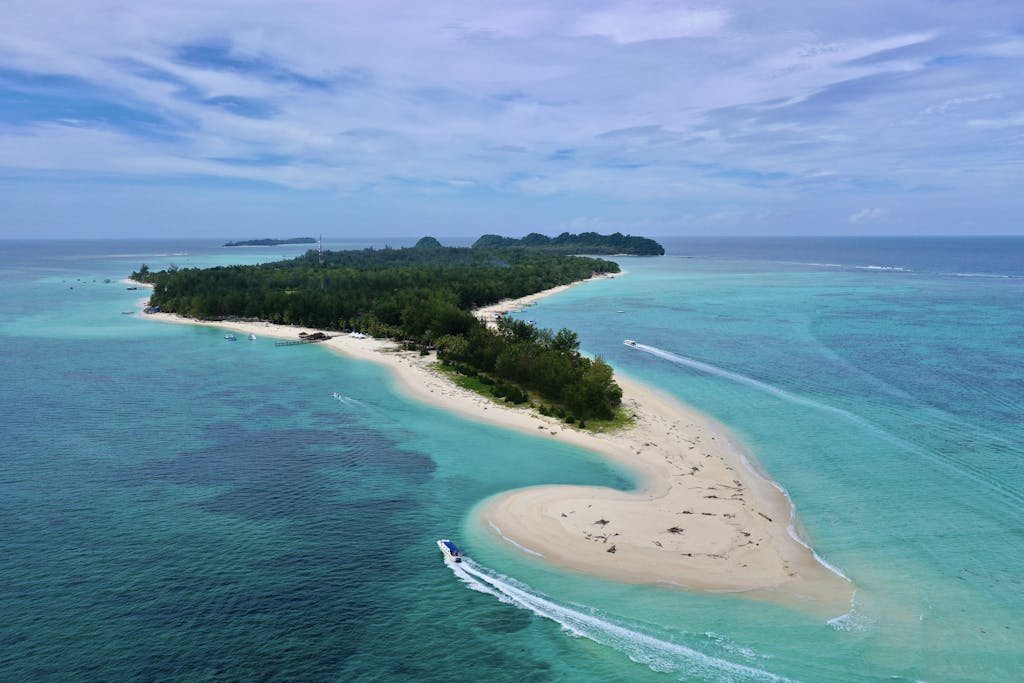 Stunning aerial view of Pulau Mantanani, Malaysia's turquoise waters and sandy beach.